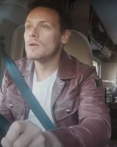 men in kilts a roadtrip with sam and graham sam heughan purple jacket